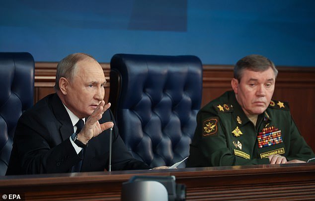Russian President Vladimir Putin and General Staff of the Russian Armed Forces Valery Gerasimov (R) attend an extended meeting of the Russian Defense Ministry board at the Russian National Defense Control Center in Moscow, Russia, on December 19, 2023