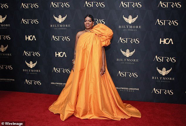 The 39-year-old singer took over the red carpet in her bright orange sleeveless dress for the star-studded event at the famed Biltmore Hotel