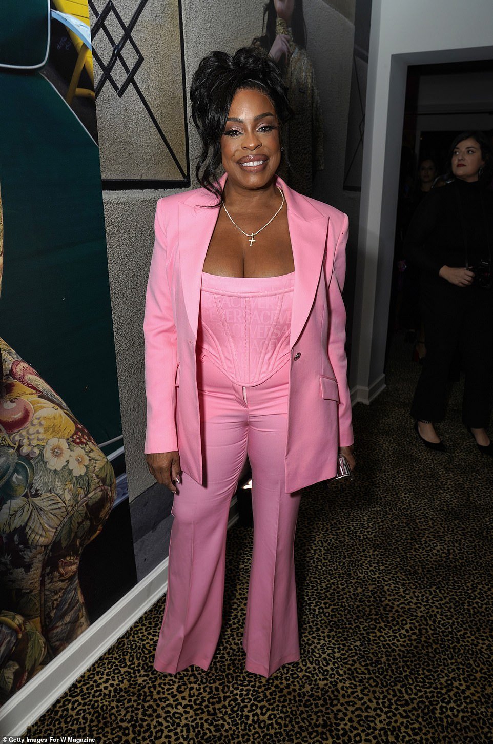 Niecy Nash-Betts radiated effortlessly in pink trousers, a fitted corset top and a matching blazer