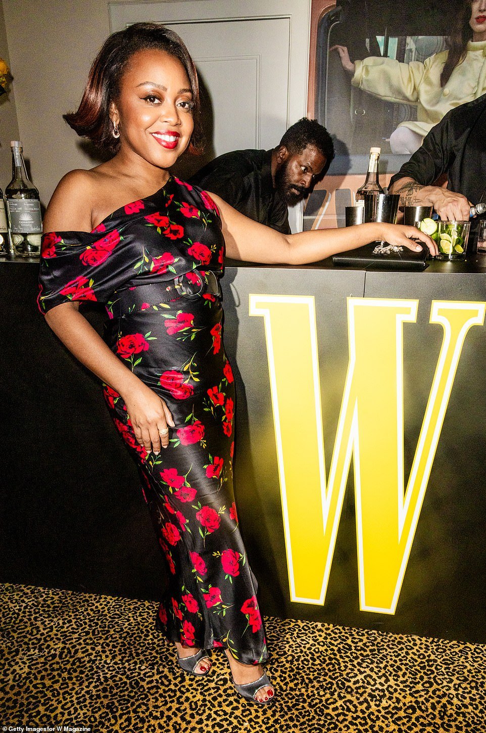 Abbott Elementary star, Quinta Brunson, was elegantly showcased in a black, figure-hugging dress with red floral detailing throughout the fabric