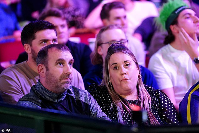 Littler's father Anthony and mother Lisa watch the action at Alexandra Palace