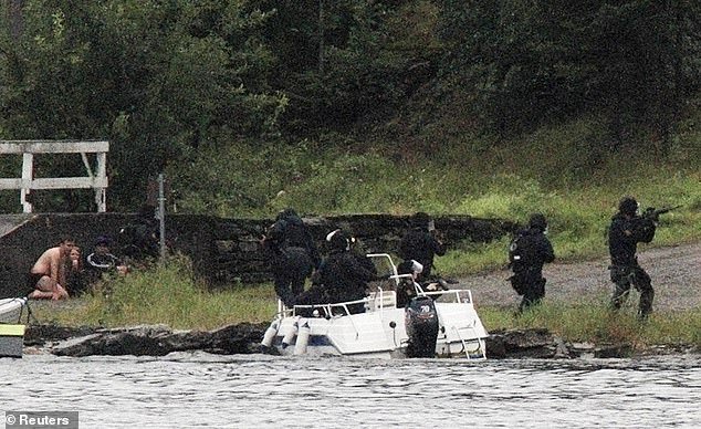 Breivik then drove to the island of Utøya, where he opened fire on the annual summer camp of the youth wing of the left-wing Labor Party.  Sixty-nine people were killed there, most of them teenagers, before Breivik surrendered to the police (photo: young people hide as police arrive on the island on July 22, 2011)