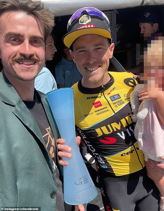 Rohan Dennis, with the award he won last year, holds his daughter during the Tour Down Under, where he will not appear because of the charges over his wife's death