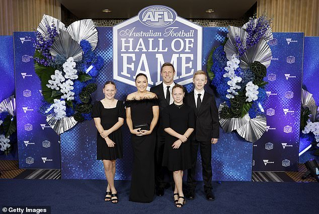 Mitchell (pictured with his wife and children at the Australian Football Hall of Fame ceremony) was released from hospital, but his 2024 season will be disrupted