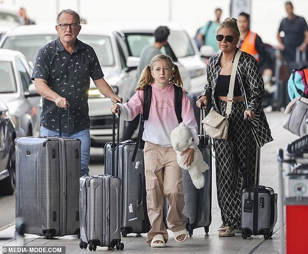 The Big Brother presenter, 58, walked through the airport with her partner of 16 years and daughter Maggie, eight, who followed closely behind her