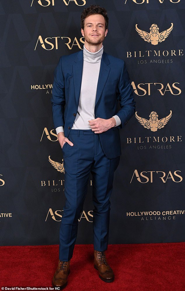 Jack Quaid was fashionable in a skimpy blue suit and light gray turtleneck paired with brown leather boots