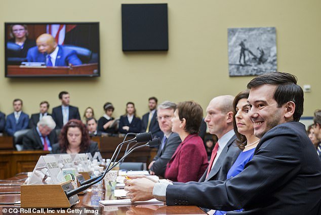 He is seen smiling at Congress as they question him about a drug that treats toxoplasmosis, a parasitic infection that threatens people with weakened immune systems