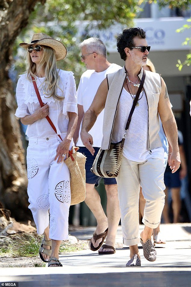The 59-year-old supermodel dressed for the summer weather in a white broderie anglaise top paired with $1,017 white Isabel Marant jeans, which featured cut-out details on both legs
