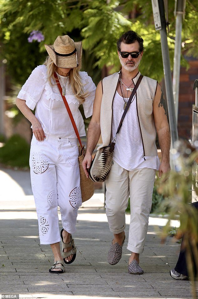 As for her boyfriend Doyle, the 54-year-old guitarist wore a white singlet layered with a beige cardigan