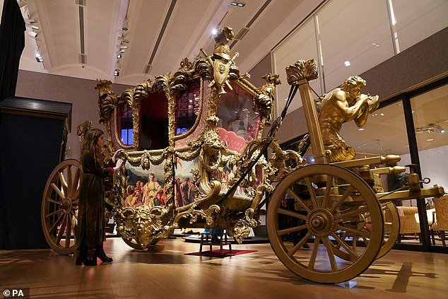 The world's only example (pictured) of the Gold State Coach is expected to sell for between £30,000 and £50,000