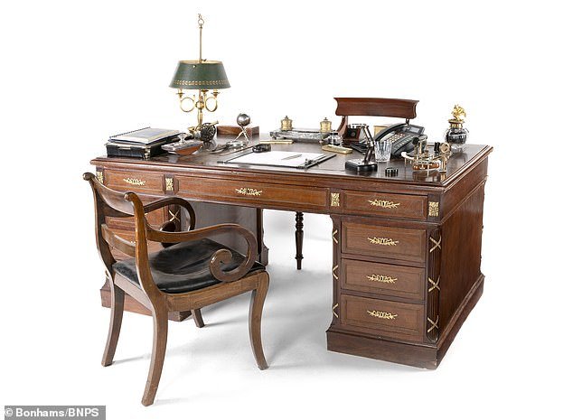 A replica of Prince Philip's mahogany and gilt metal desk from the early 20th century is valued at £5,000