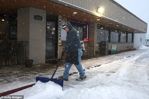 A man shovels snow in front of Horizon Family Restaurant, where Nikki Haley was scheduled to hold a Monday morning event in Sioux City, Iowa, located in the western part of the state