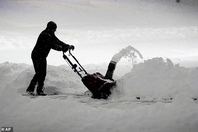 A resident shovels snow in Urbandale, Iowa, Tuesday morning