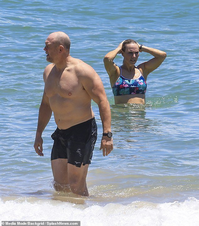 The royal showed off her athlete's figure as she splashed in and out of the water with husband Mike
