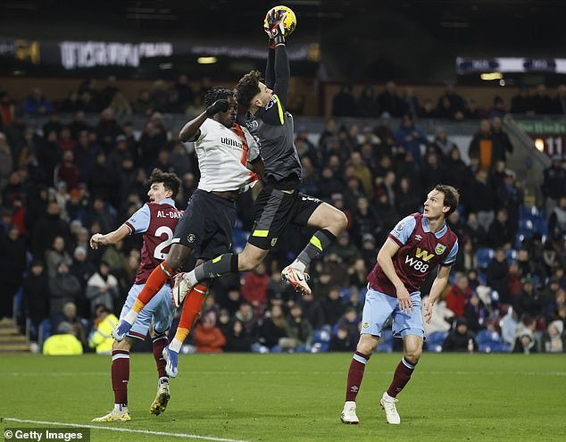 Burnley keeper Trafford catches the ball under pressure from Luton striker Adebayo