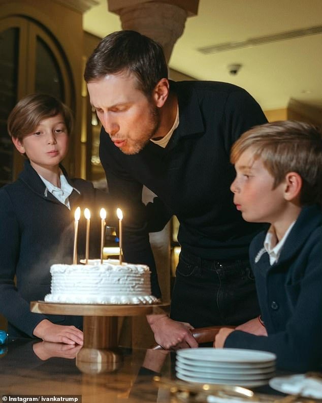 Jared's sons Theodore and Joseph help him blow out the candles on his birthday cake