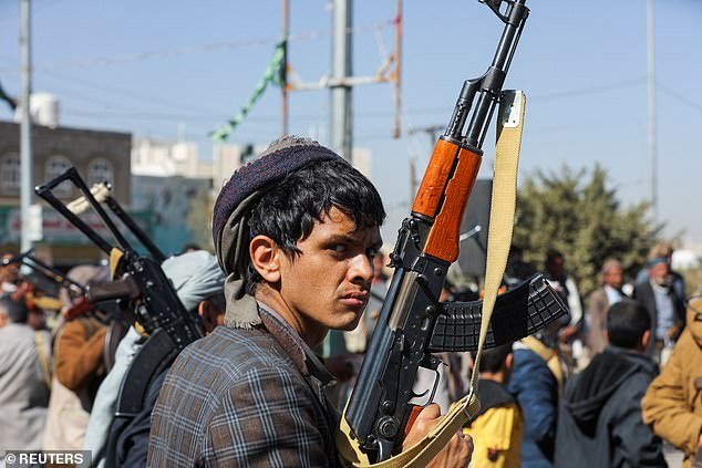 A Houthi fighter holds his rifle during a ceremony marking the end of his training