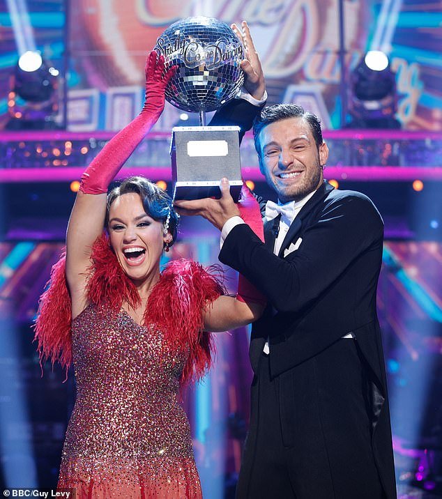 Ellie and Vito raised the glitterball trophy as fireworks sparked and confetti fell from the ceiling as they were lifted onto the shoulders of their former competitors