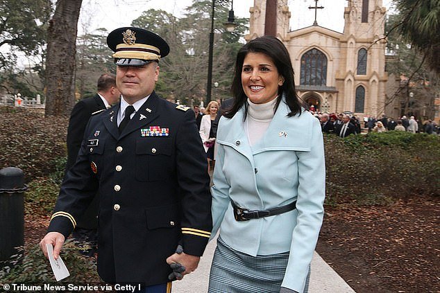 Nikki Haley is seen in 2015 with her husband Michael, a businessman and commissioned officer in the South Carolina Army National Guard.  Haley regularly cites her husband as a major reason for her presidential bid and features him in campaign ads.