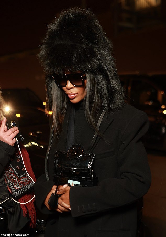 She was later seen wearing a fur hat as she arrived at Costes restaurant in the city after the show