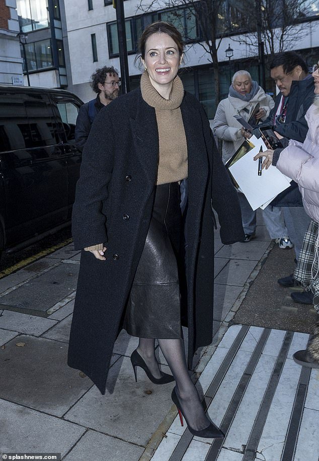 The British actress completed her ensemble with a beige turtleneck and a black maxi coat as she bundled up in the cold weather