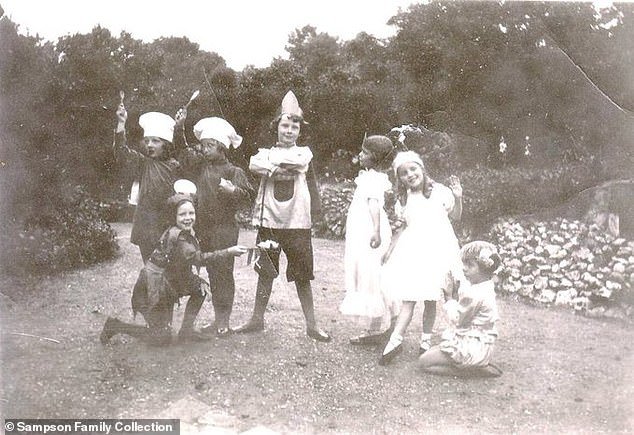 Hepburn (above centre) is seen dressed up with other children during her stay in Elham, Kent