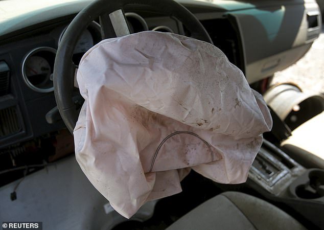 A deployed Takata-manufactured airbag is seen on the driver's side of a 2007 Dodge Charger in a recycled car parts lot in Detroit