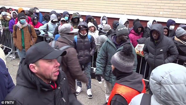 A fight has broken out among a crowd of 300 migrants waiting outside in the cold for shelter in New York City ahead of a major snowstorm to hit the East Coast.