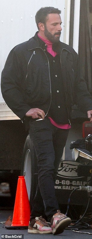 Affleck paired his sneakers with an all-black look, worn over a bright pink turtleneck