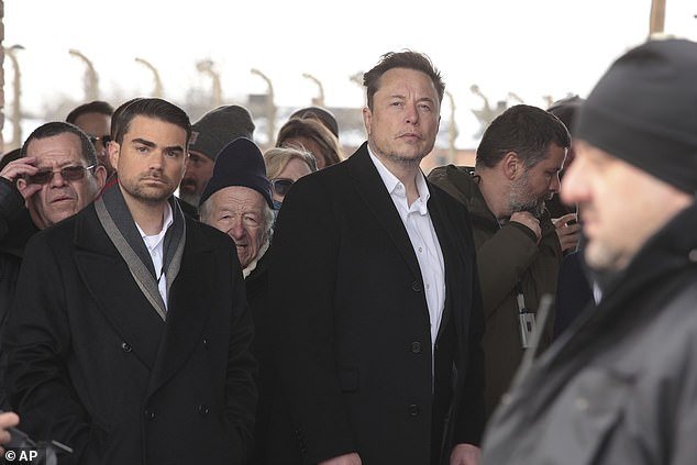 Musk pictured next to Ben Shapiro at the site of the Nazi German Auschwitz-Birkenau death camp in Oswiecim, Poland
