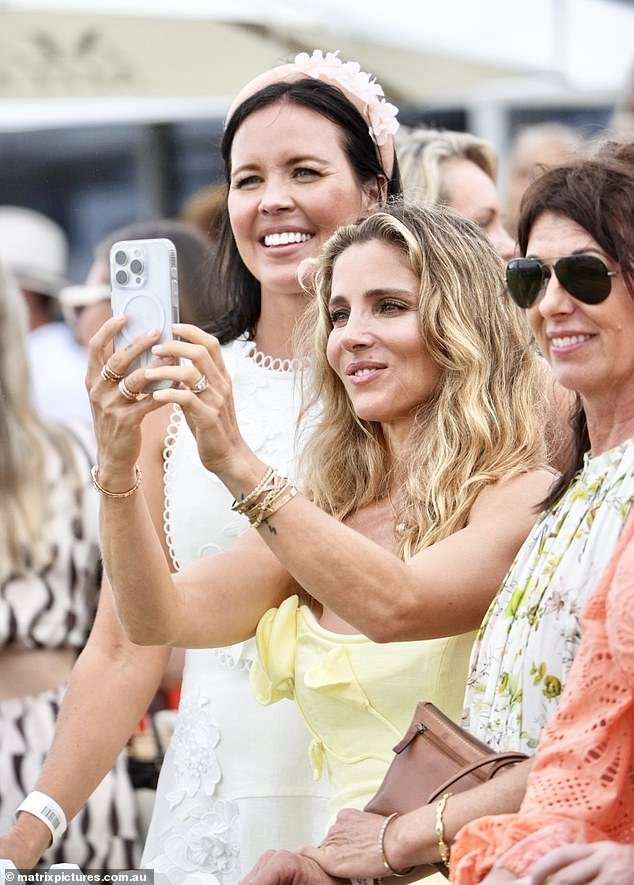 Elsa Pataky (center) has once again poured cold water on rumors that she and husband Chris Hemsworth have grown apart by showing off her diamond engagement ring at the Magic Millions in Queensland on Sunday