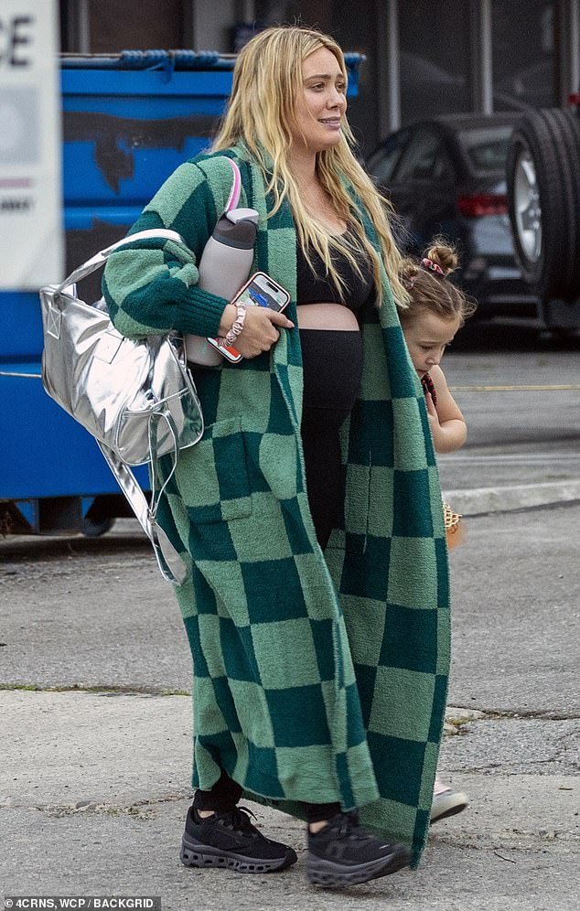 The 36-year-old Lizzie McGuire sensation was dressed comfortably in a black sports bra and leggings topped with a plaid green jacket