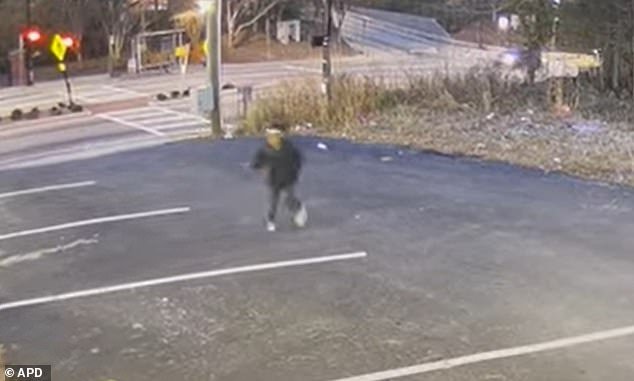 The footage shows the boy (pictured) looking over his shoulder as he sprints through a parking lot just off Martin Luther King Drive in northwest Atlanta on January 15.