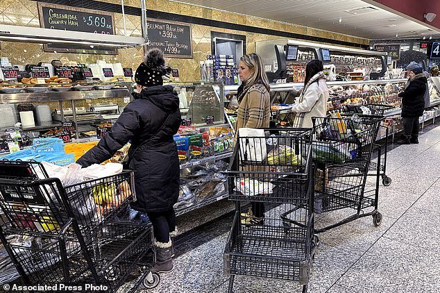 Customers wait for orders at a supermarket in Wheeling, Illinois, Friday, January 19, 2024. On Friday, the Commerce Department will release its December report on consumer spending.  (AP Photo/Name Y. Huh)