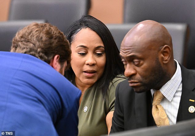Fulton DA Fani Willis (center) confers with lead prosecutors Donald Wakeford (left) and Nathan Wade during a hearing at the Fulton County Courthouse in Atlanta on Friday, July 1, 2022