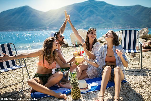 Watching the pennies: Young people on holiday are increasingly spending cash as it helps them keep control of their money, a study shows