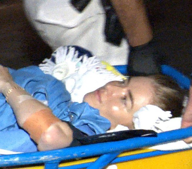 Mrs O'Neill is pictured on a stretcher moments after she was attacked by a shark on Monday