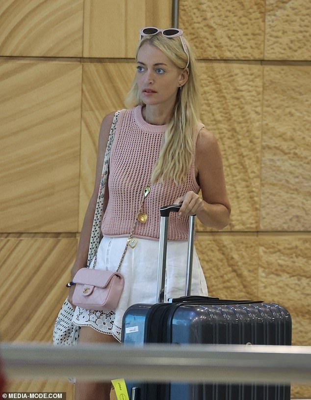 She paired her look with a matching pale pink Chanel bag that costs around $8,200, plus a pair of nude sandals and pink Christian Dior sunglasses.