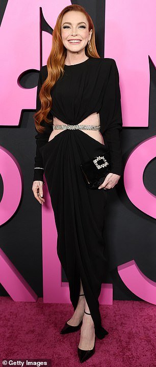 Lohan radiated effortlessly in a fitted black dress with cutouts at the sides