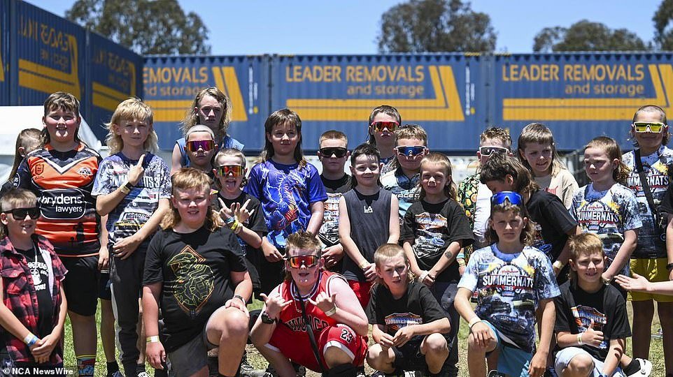 A group of children pose for a photo to show off their mullets at the Summernats festival