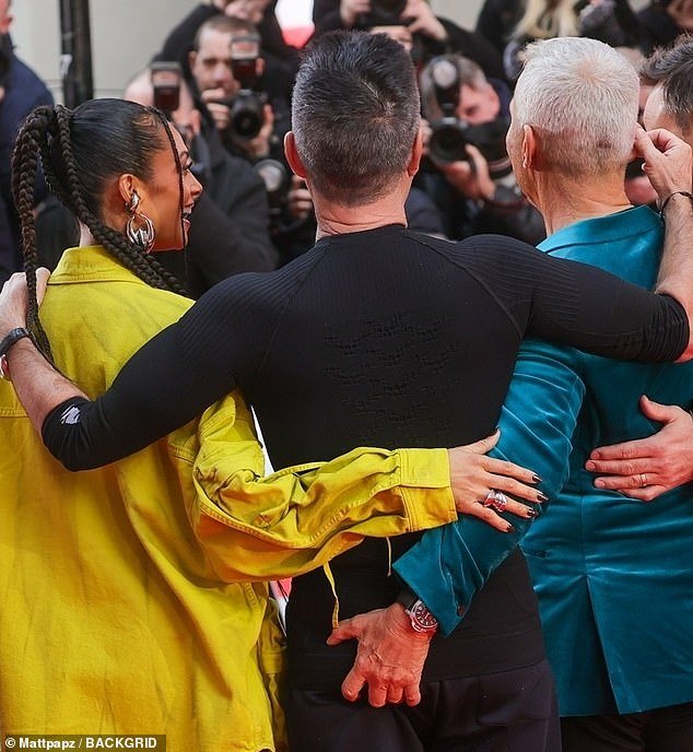 The Italian dancer promptly responded by grabbing a handful of Cowell's backside as the four judges stood shoulder to shoulder.