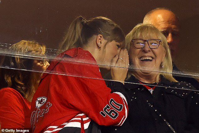 Donna laughed when Taylor whispered something to her during the loud sporting event