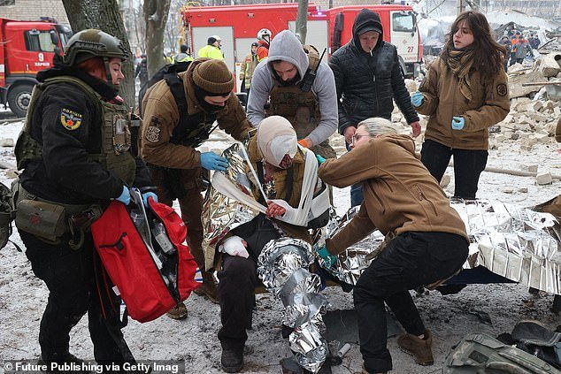First responders provide first aid to an injured person after the Russian missile attack on Kharkiv, January 23, 2024
