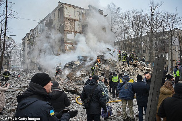 Ukrainian rescue and aid workers visit the site of a rocket attack in Kharkov on January 23, 2024