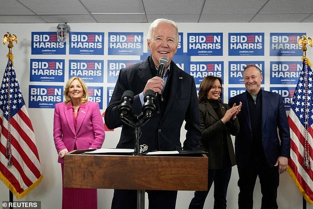 President Joe Biden speaks with campaign staff as first lady Jill Biden, Vice President Kamala Harris and second gentleman Doug Emhoff listen