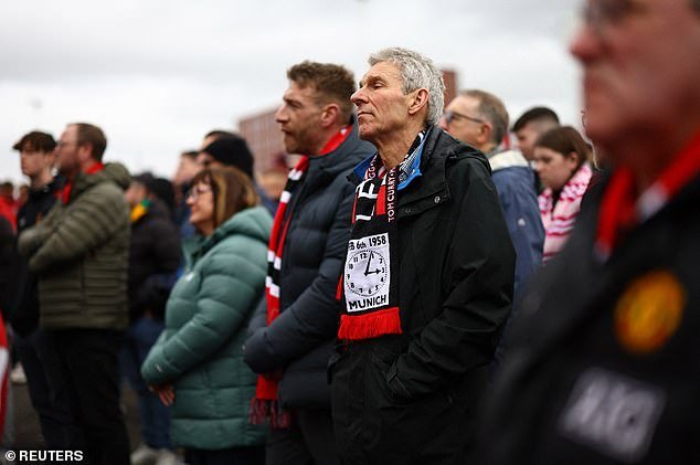 The fans were pictured wearing commemorative scarves that read: 'Forever remembered.  The busy babes stood outside in the cold