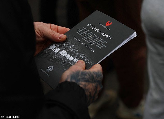 The United fans were also seen holding an event brochure, which showed a photo of those who had died in the crash at the front