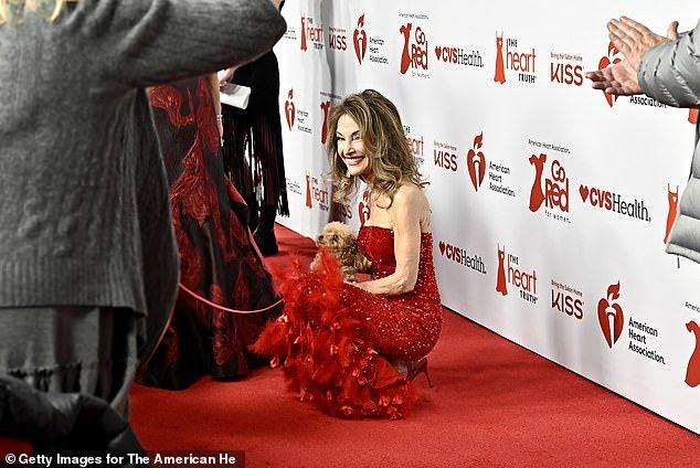 Here she was seen playing with a small dog while on the red carpet