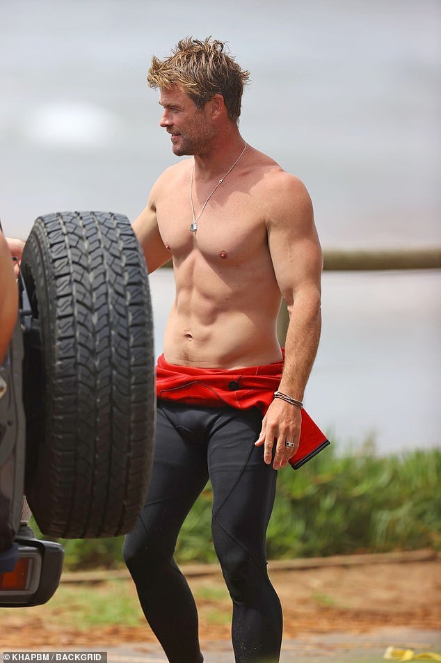 Chris' rippling muscles were clearly visible as he stood by his car