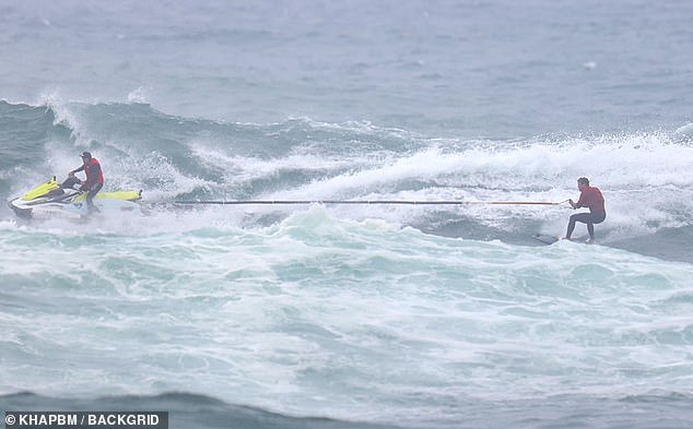 After the tow, they were seen enjoying a surf in the rough conditions